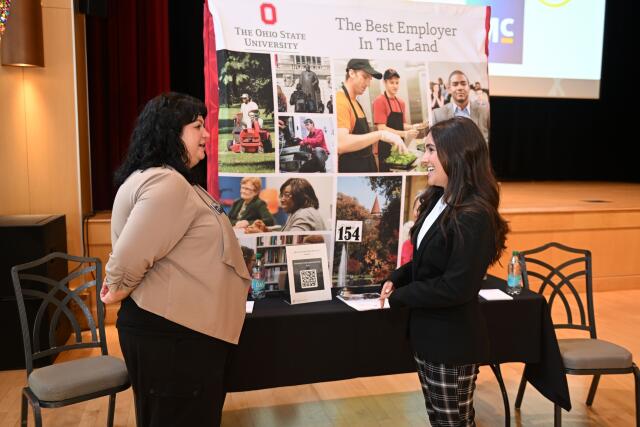 At the Ohio State University Career and Internship Fair, a student talks to an employer