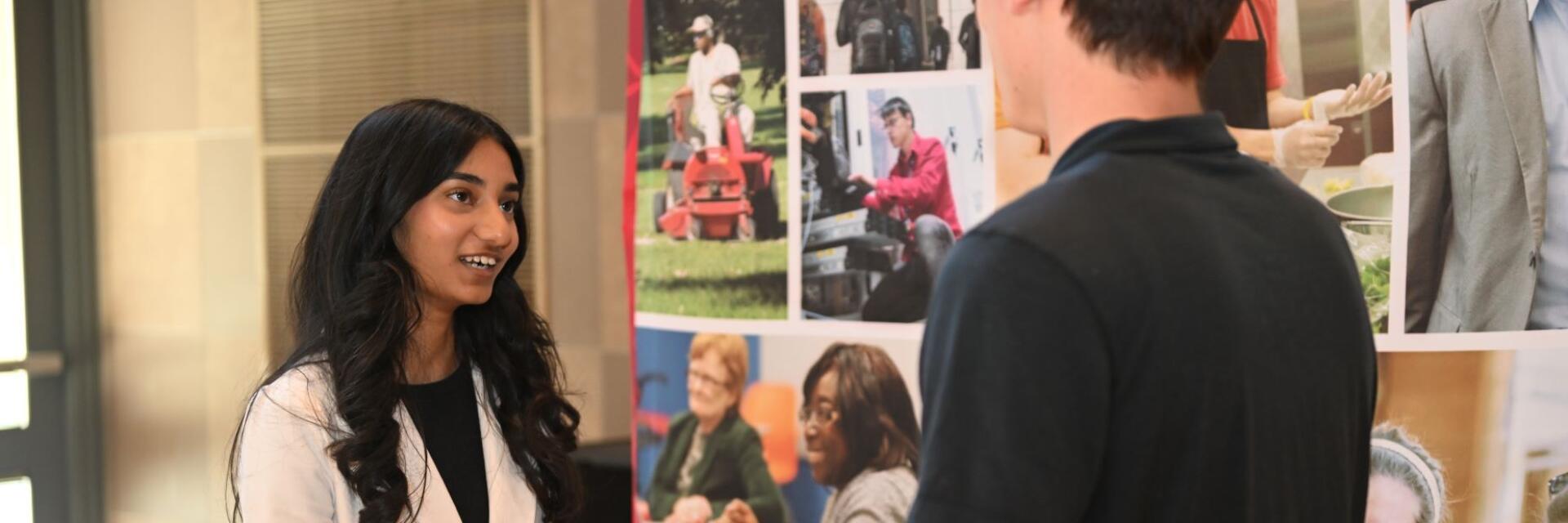 Ohio State student speaking with an employer during a career fair