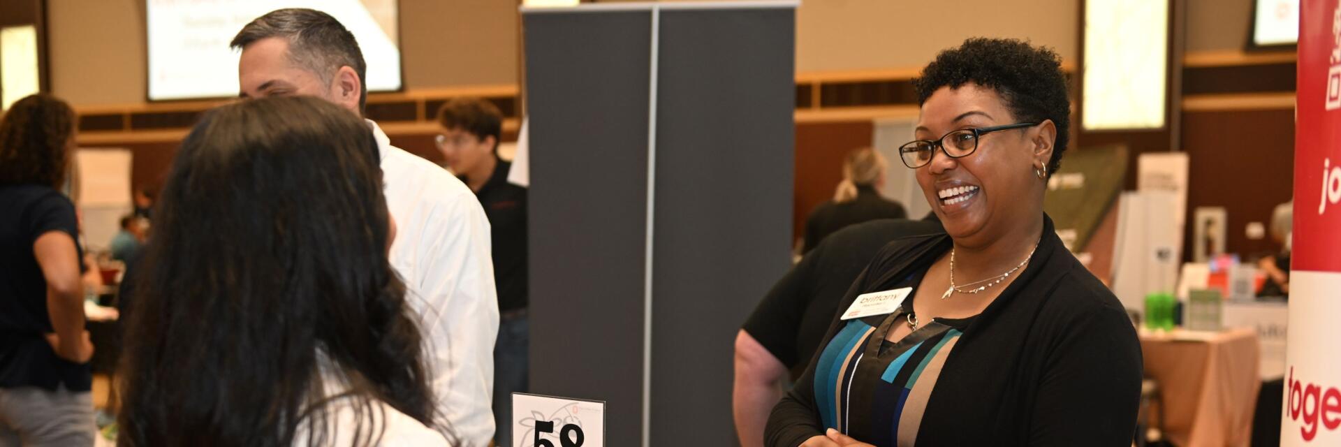 student talking to employer at a career fair